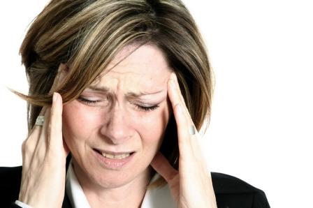 A woman suffering with a migraine headache